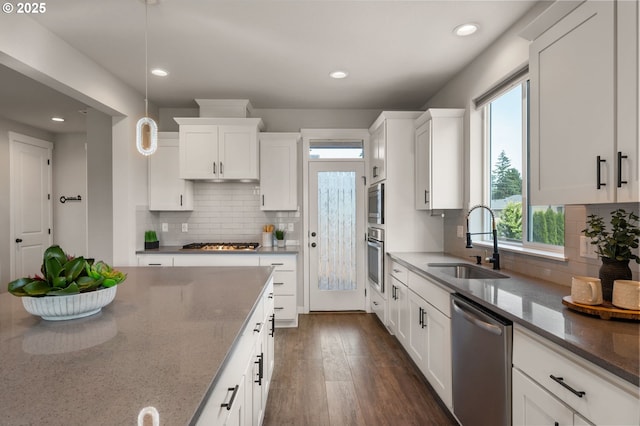 17085 SE Troge Rd, Happy Valley, OR 97086 - kitchen featuring appliances with stainless steel finishes, white cabinets, dark wood finished floors, light stone counters, and recessed lighting