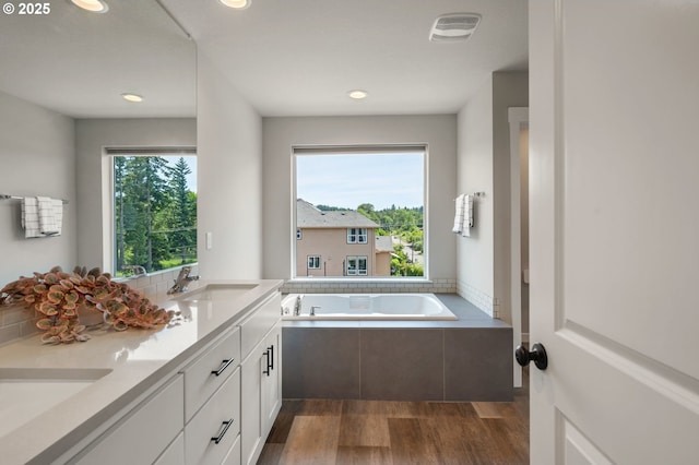 17085 SE Troge Rd, Happy Valley, OR 97086 - bathroom with wood finished floors, a garden tub, double vanity, and recessed lighting