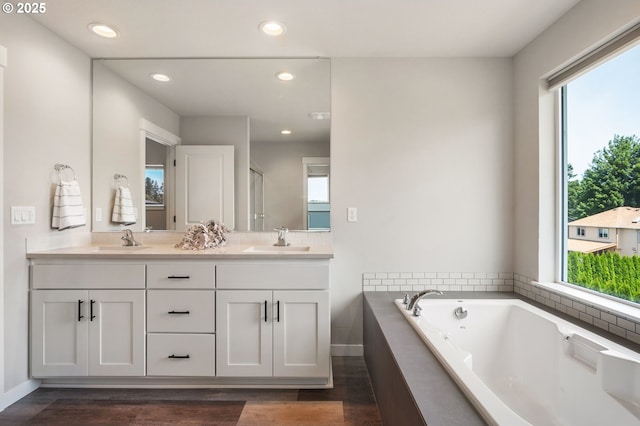17085 SE Troge Rd, Happy Valley, OR 97086 - full bath with healthy amount of natural light, double vanity, a garden tub, wood finished floors, and recessed lighting
