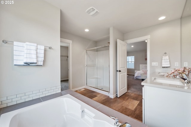 17085 SE Troge Rd, Happy Valley, OR 97086 - full bathroom with wood finished floors, a shower stall, recessed lighting, a bath, and double vanity