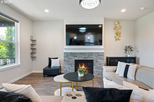 17085 SE Troge Rd, Happy Valley, OR 97086 - living room featuring wood finished floors, recessed lighting, a fireplace, and a chandelier