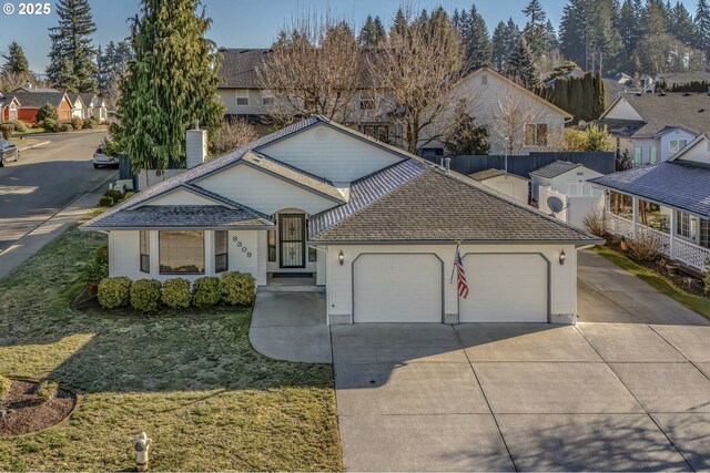 view of front facade with a garage and a front yard