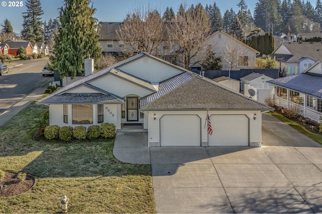 view of front of property featuring a garage and a front yard