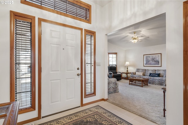 carpeted foyer entrance with lofted ceiling and ceiling fan