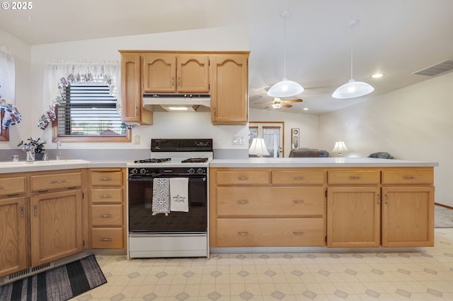 kitchen featuring white range with gas cooktop, hanging light fixtures, lofted ceiling, and sink