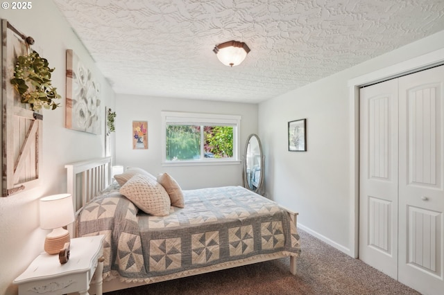 carpeted bedroom with a textured ceiling and a closet