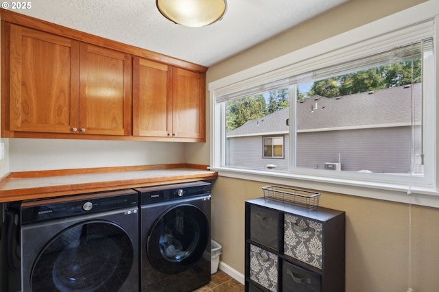 laundry room with cabinet space, independent washer and dryer, and baseboards