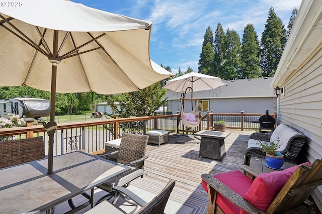 wooden terrace featuring an outdoor fire pit