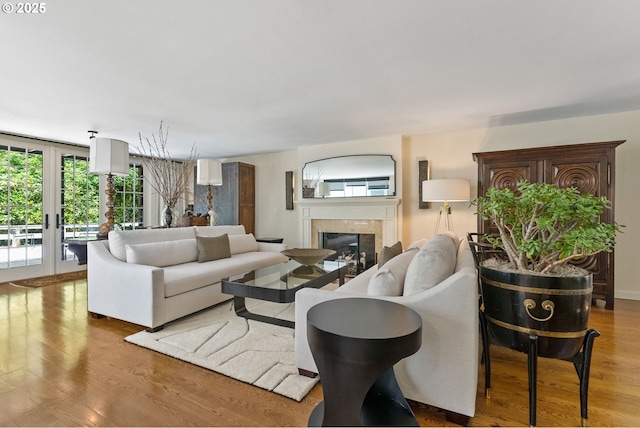 2917 Westview Cir, Lake Oswego, OR 97034 - living area featuring a tiled fireplace, wood finished floors, and french doors