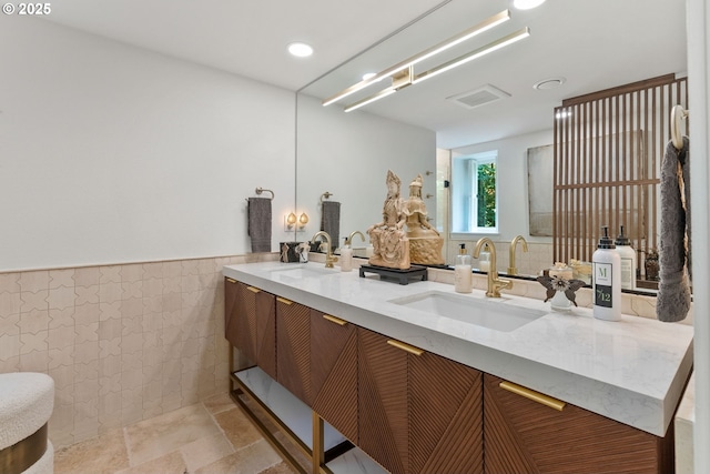 2917 Westview Cir, Lake Oswego, OR 97034 - bathroom featuring double vanity, tile walls, wainscoting, recessed lighting, and stone finish flooring