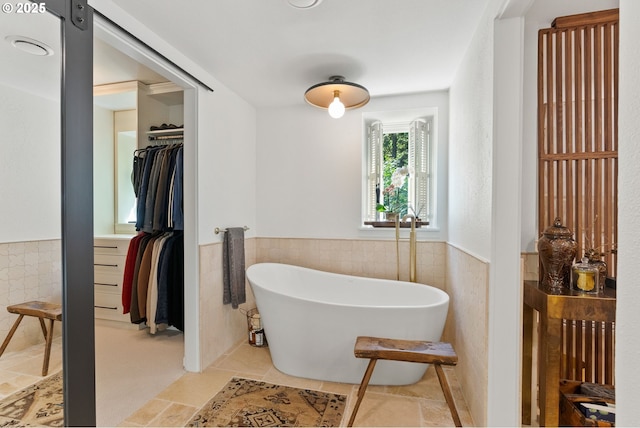 2917 Westview Cir, Lake Oswego, OR 97034 - bathroom with wainscoting, tile walls, a soaking tub, and a walk in closet