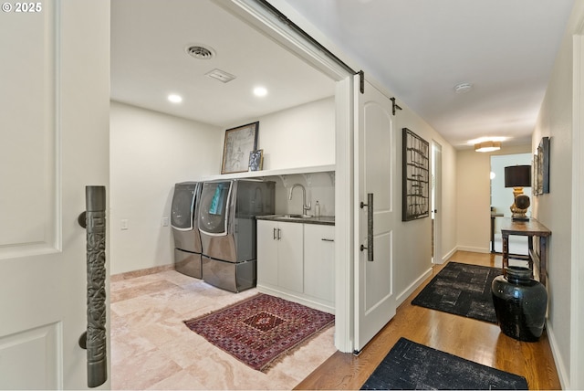 2917 Westview Cir, Lake Oswego, OR 97034 - laundry area with washer and dryer, wood finished floors, cabinet space, bar with sink, and baseboards