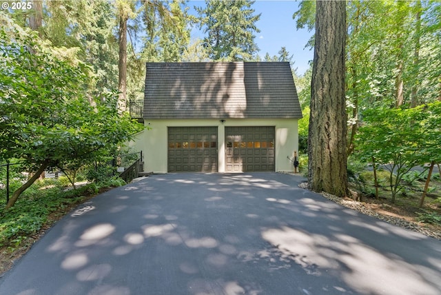 2917 Westview Cir, Lake Oswego, OR 97034 - view of home's exterior with stucco siding, a garage, and an outdoor structure