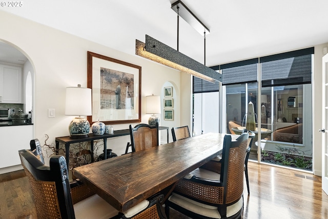 2917 Westview Cir, Lake Oswego, OR 97034 - dining room featuring arched walkways, light wood-style floors, and healthy amount of natural light
