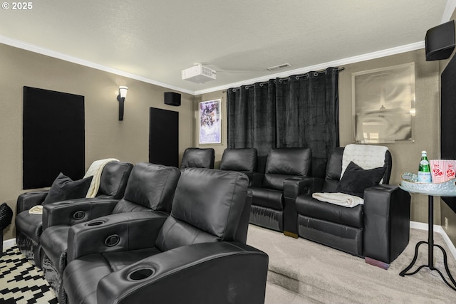 cinema room with carpet floors, visible vents, crown molding, and baseboards