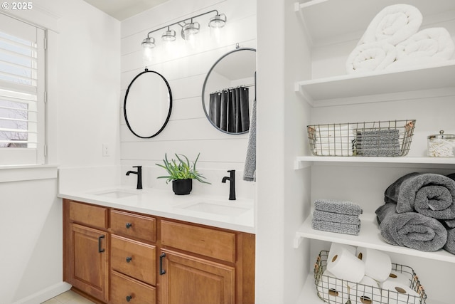 full bathroom featuring double vanity and a sink