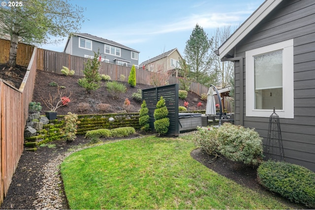 view of yard featuring a fenced backyard and a hot tub