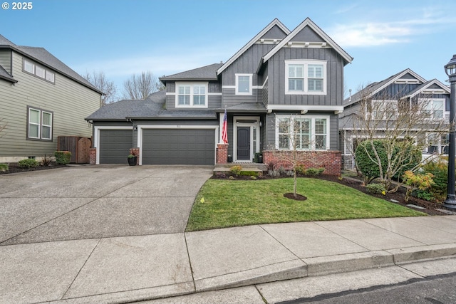 craftsman-style house featuring driveway, an attached garage, a front lawn, board and batten siding, and brick siding