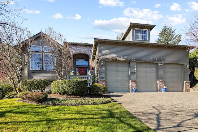 view of front of house with a garage and a front yard