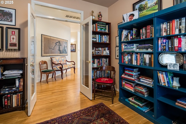 sitting room featuring hardwood / wood-style flooring and french doors