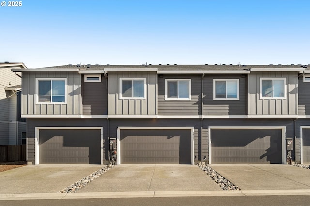 townhome / multi-family property featuring driveway, a garage, and board and batten siding