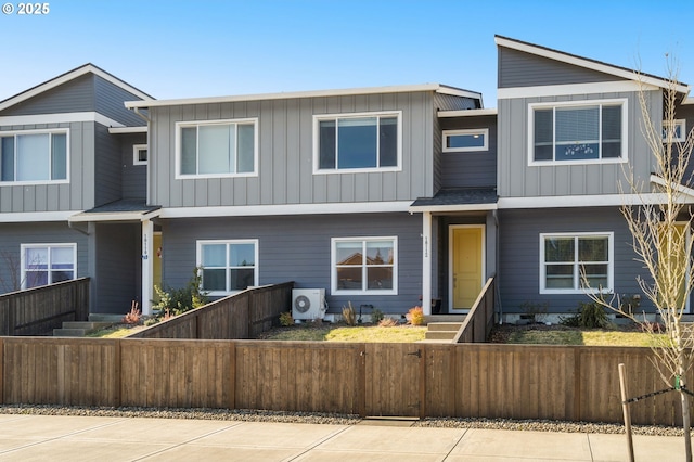 view of front of home featuring a fenced front yard, ac unit, and board and batten siding