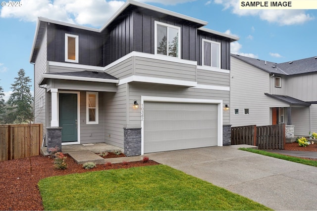 view of front of home featuring a garage and a front lawn