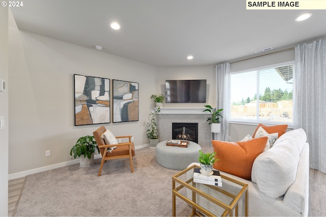 living room with a tiled fireplace