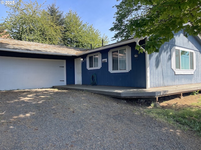 414 NW 5th St, Willamina, OR 97396 - view of front of house featuring a garage and gravel driveway