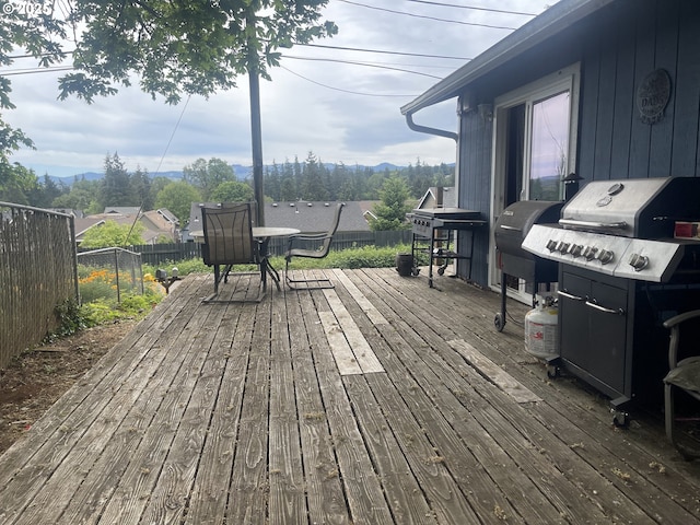 414 NW 5th St, Willamina, OR 97396 - deck with fence, a mountain view, and grilling area