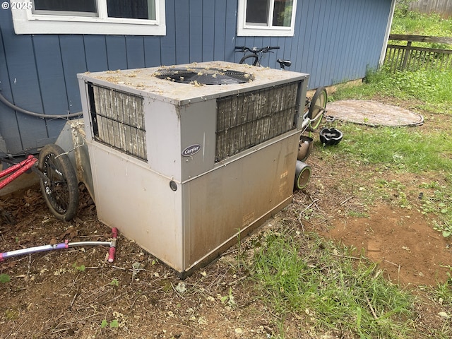 414 NW 5th St, Willamina, OR 97396 - exterior view of central air condition unit, fence, and board and batten siding