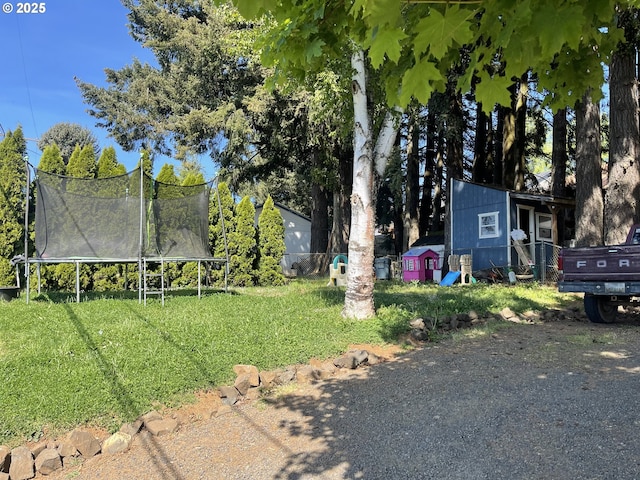 414 NW 5th St, Willamina, OR 97396 - view of green lawn with a trampoline, a shed, and an outdoor structure
