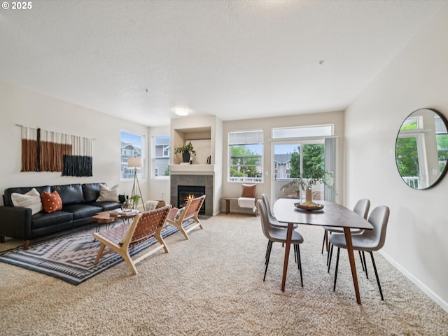 8710 SW 147th Ter Unit 104, Beaverton, OR 97007 - dining space with carpet flooring, plenty of natural light, and a tiled fireplace