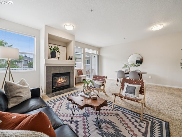 8710 SW 147th Ter Unit 104, Beaverton, OR 97007 - carpeted living area featuring plenty of natural light, a fireplace, and a textured ceiling