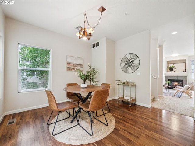 8710 SW 147th Ter Unit 104, Beaverton, OR 97007 - dining space featuring hardwood / wood-style floors, a chandelier, a fireplace, and recessed lighting