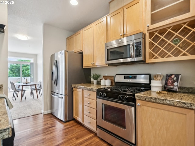 8710 SW 147th Ter Unit 104, Beaverton, OR 97007 - kitchen featuring appliances with stainless steel finishes, light brown cabinetry, dark wood finished floors, and recessed lighting