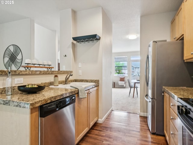 8710 SW 147th Ter Unit 104, Beaverton, OR 97007 - kitchen with appliances with stainless steel finishes, dark wood-style floors, and light brown cabinetry