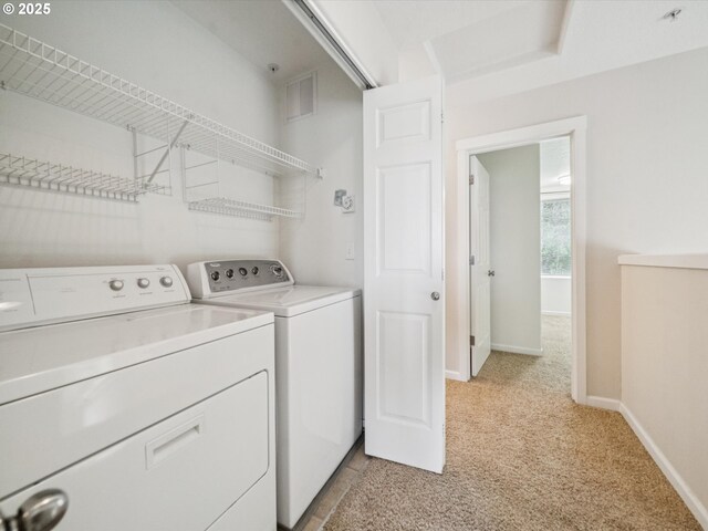 8710 SW 147th Ter Unit 104, Beaverton, OR 97007 - laundry area with light carpet and independent washer and dryer