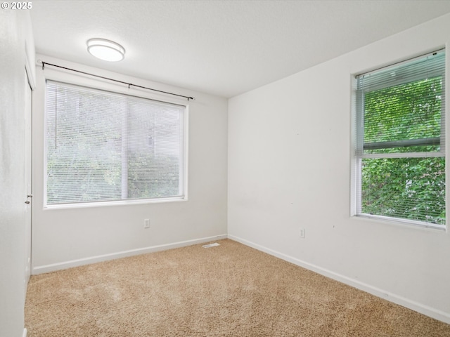 8710 SW 147th Ter Unit 104, Beaverton, OR 97007 - unfurnished room featuring carpet floors and plenty of natural light
