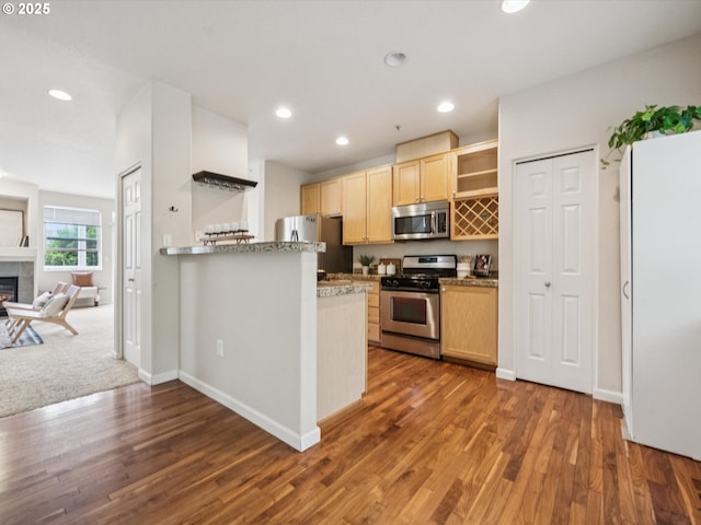8710 SW 147th Ter Unit 104, Beaverton, OR 97007 - kitchen with stainless steel appliances, open shelves, light brown cabinets, wood finished floors, and recessed lighting