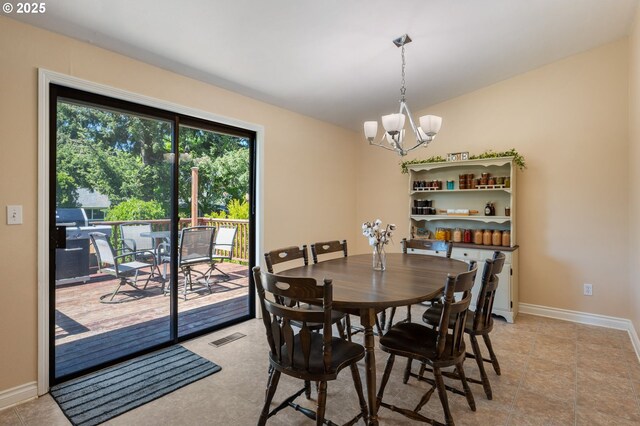 dining room featuring a chandelier, baseboards, and light tile patterned floors