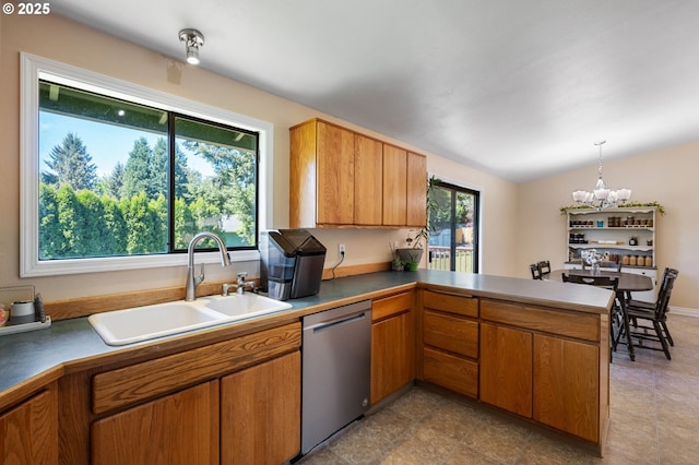 kitchen featuring dishwasher, a sink, a chandelier, a peninsula, and brown cabinets