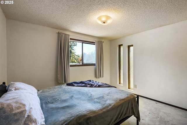 bedroom featuring carpet flooring and a textured ceiling