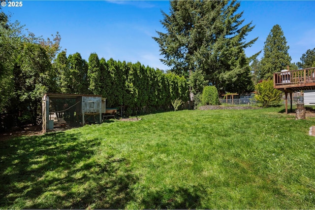 view of grassy yard featuring a deck