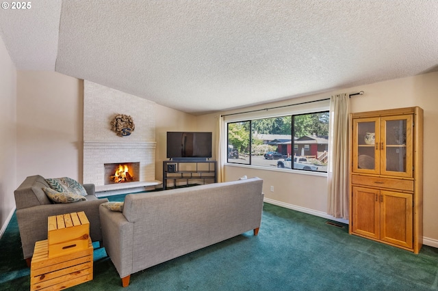 living area with a textured ceiling, dark carpet, a fireplace, vaulted ceiling, and baseboards
