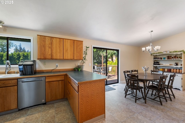 kitchen featuring stainless steel dishwasher, a peninsula, a chandelier, brown cabinetry, and lofted ceiling