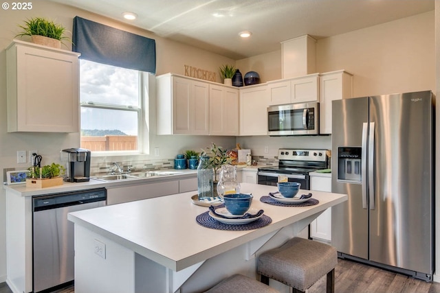 2969 U St, Springfield, OR 97477 - kitchen featuring stainless steel appliances, a sink, light countertops, white cabinetry, and dark wood finished floors