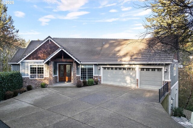 view of front of house with a garage and french doors