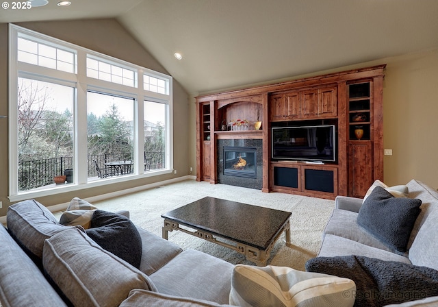 living room with lofted ceiling, recessed lighting, a glass covered fireplace, and light colored carpet