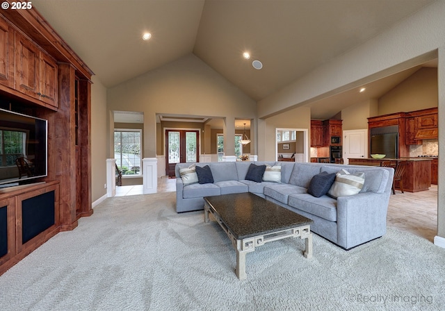 living room featuring light carpet and high vaulted ceiling